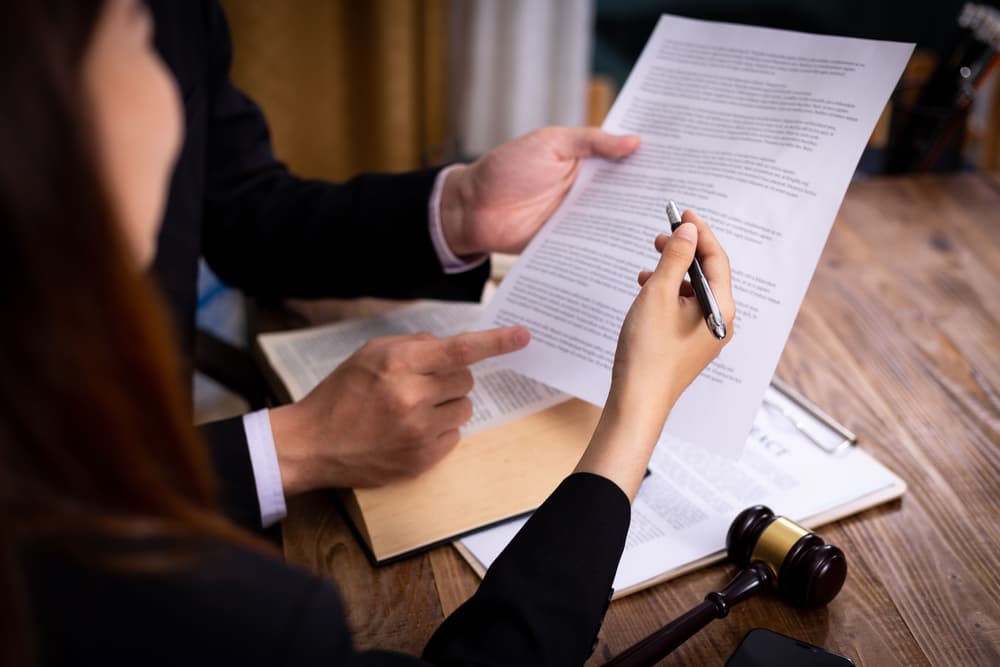 Businessman meeting with a lawyer or judge for mediation and consultation, discussing legal services and government help.