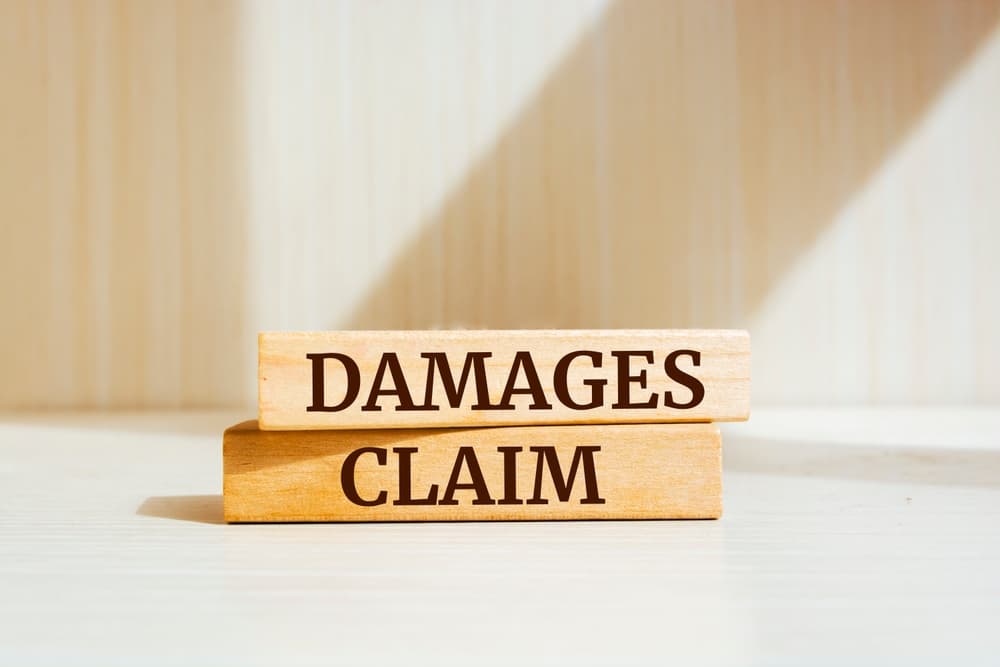 Damages & Claim written on wooden blocks