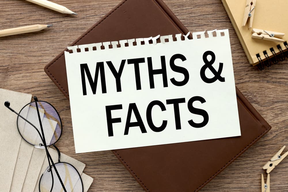 Myth and Fact written on notebook which is available on a wooden table