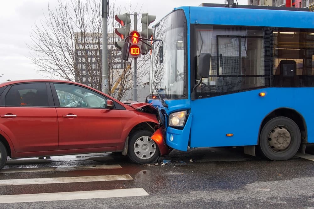 Frontal collision of a car and a bus.